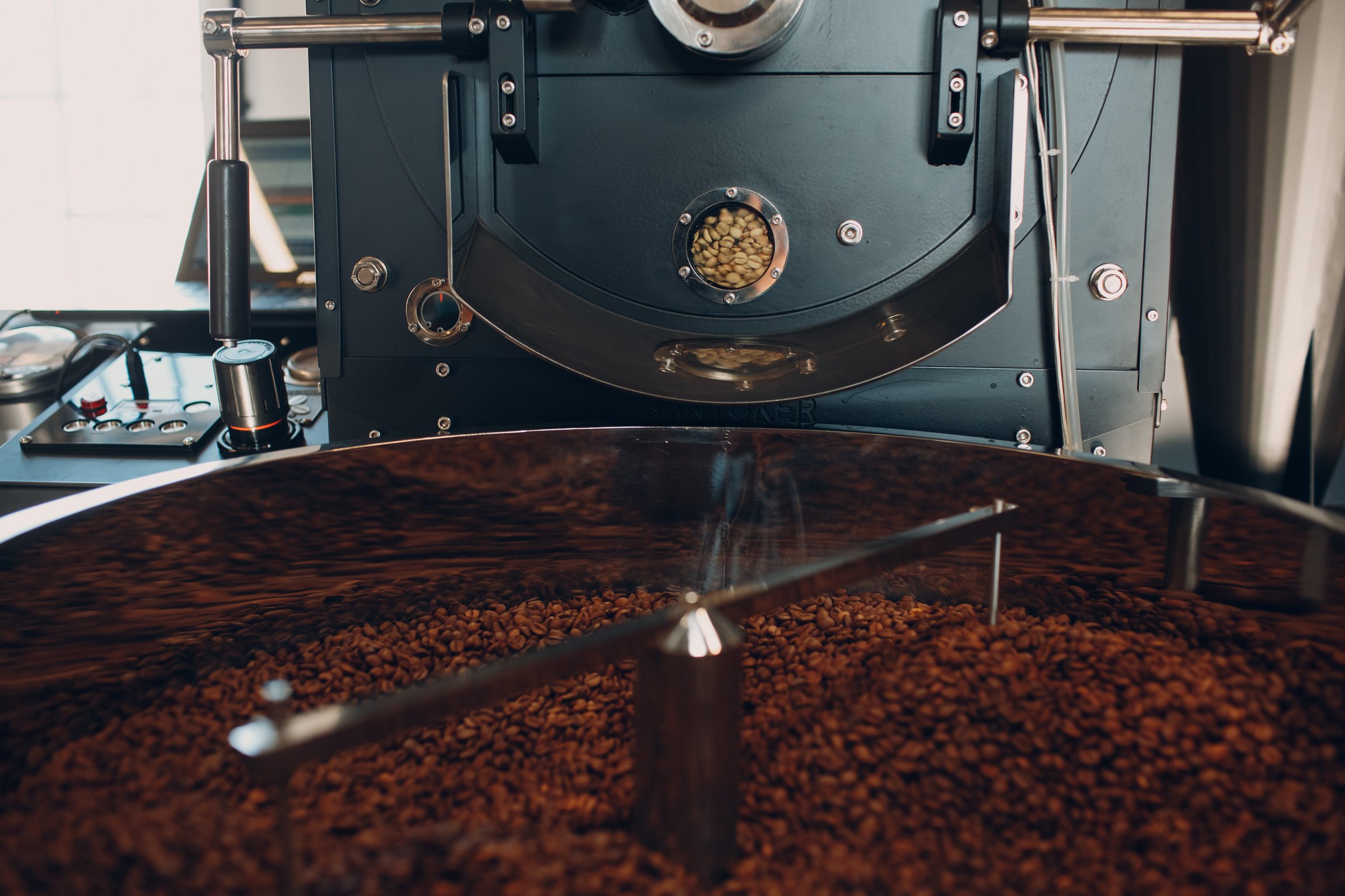 Coffee Roaster Machine at Coffee Roasting Process. Mixing Coffee Beans.